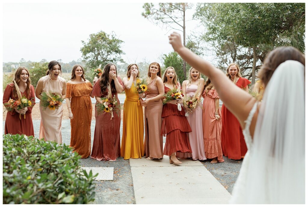 Bride doing her first look with her bridesmaids captured by Holly Ann Co as a St. Simons Wedding photographer    