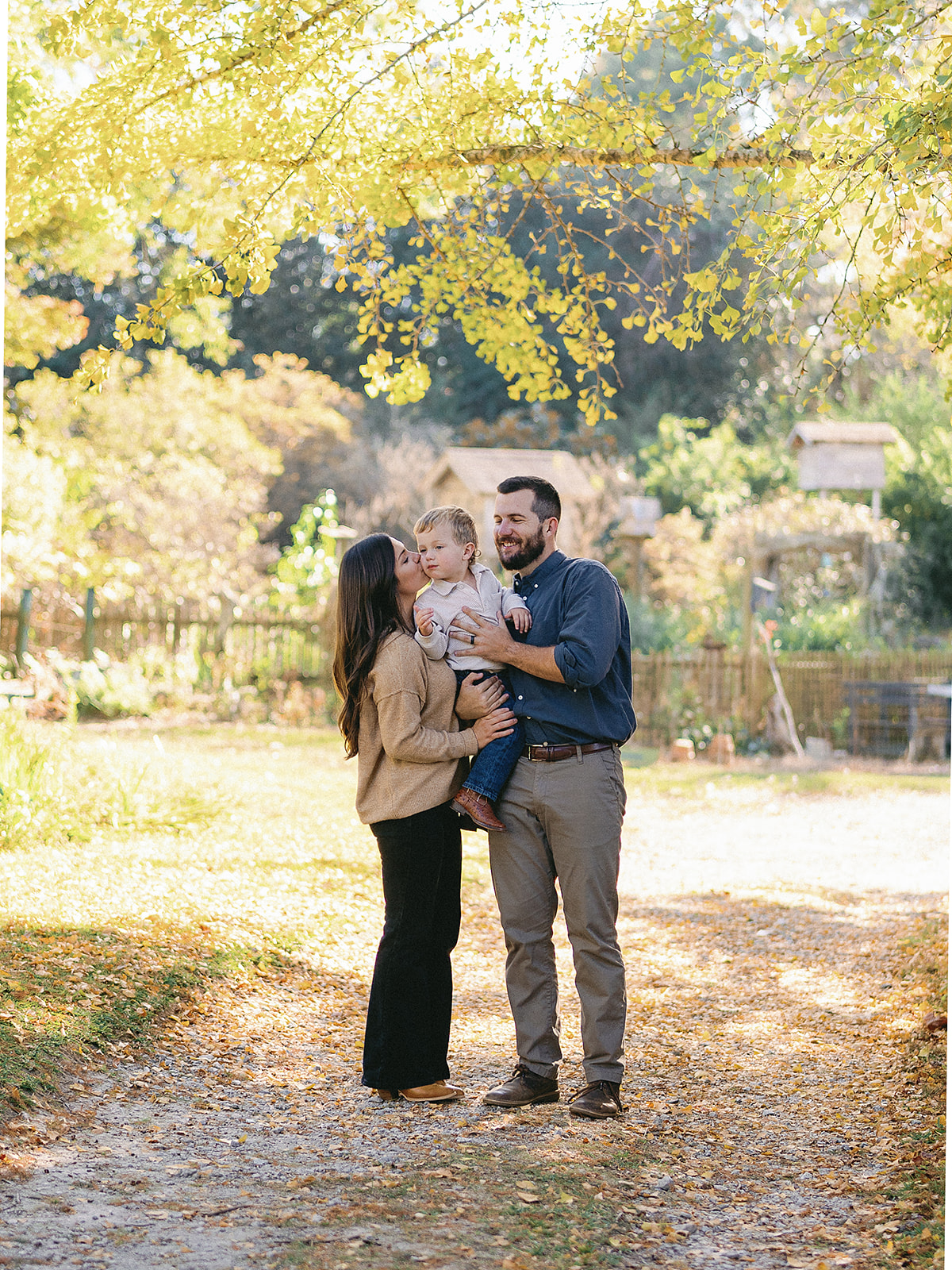 Fayetteville GA Family session mom, dad, and 4 year old boy cozying up together outside during their family session by Holly Ann Co. Photography